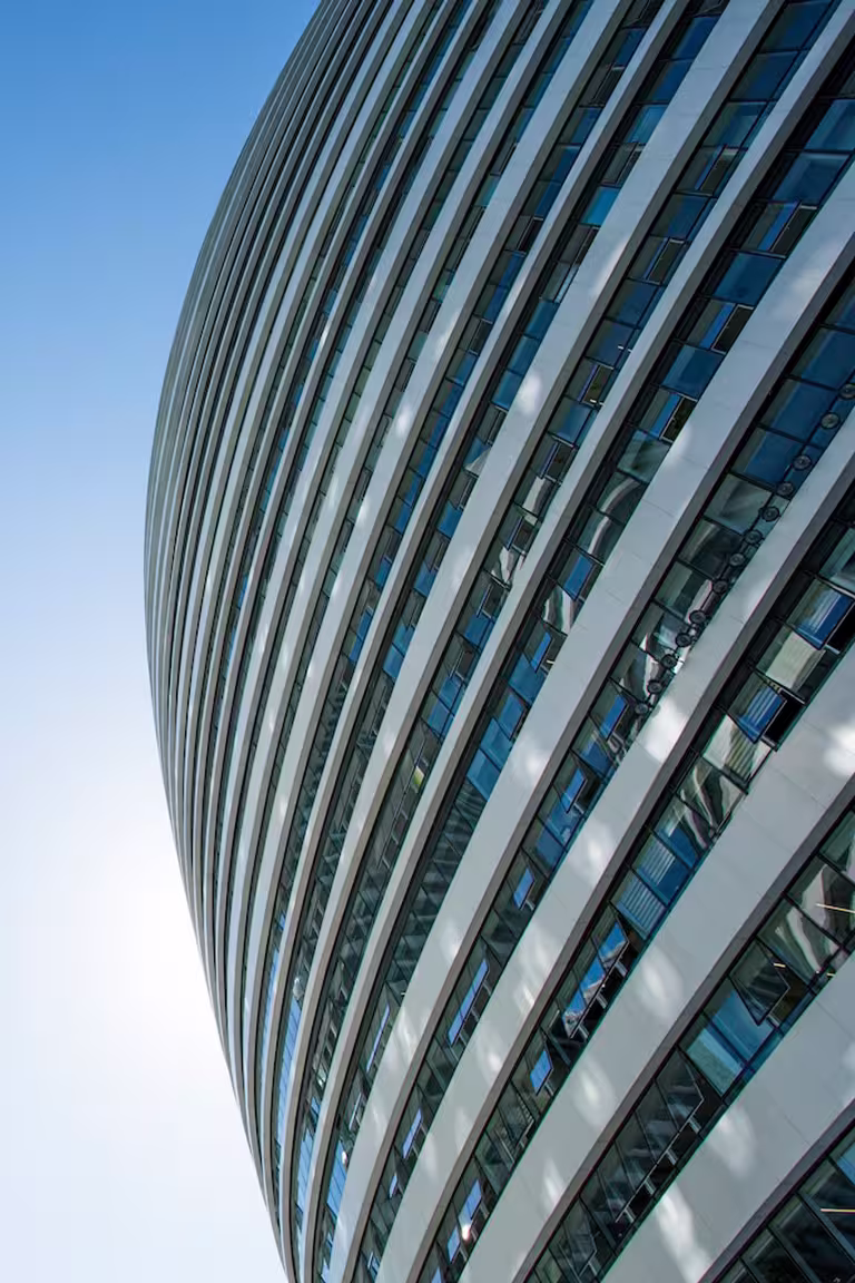 Blue chess pieces aligned against a vertical building backdrop—symbolizing ARCSA CAPITAL’s institutional real estate investment strategy and predictable fixed-income discipline in Miami.